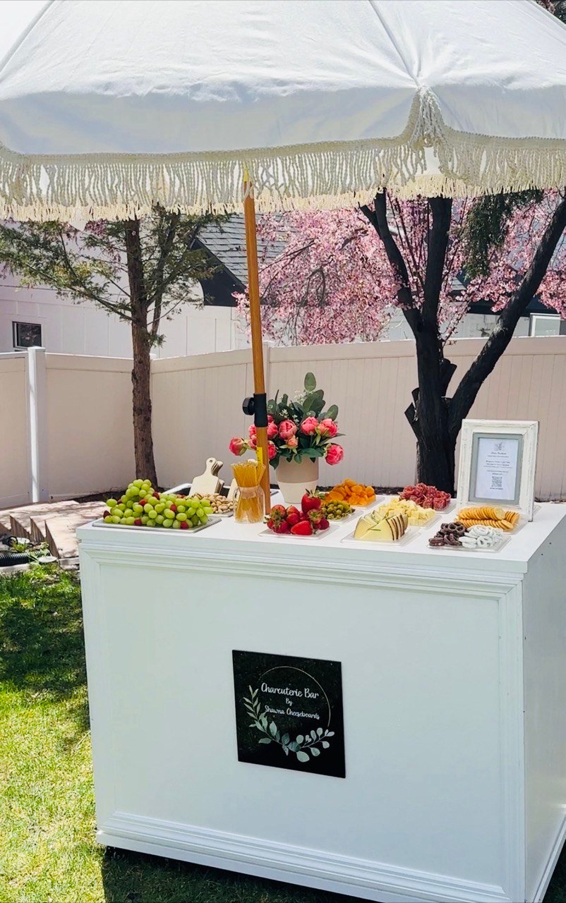 Shawna Cheeseboards charcuterie bar setup with assorted cheeses, cured meats, fruits, nuts and accompaniments for a build‑your‑own board experience in Reno NV