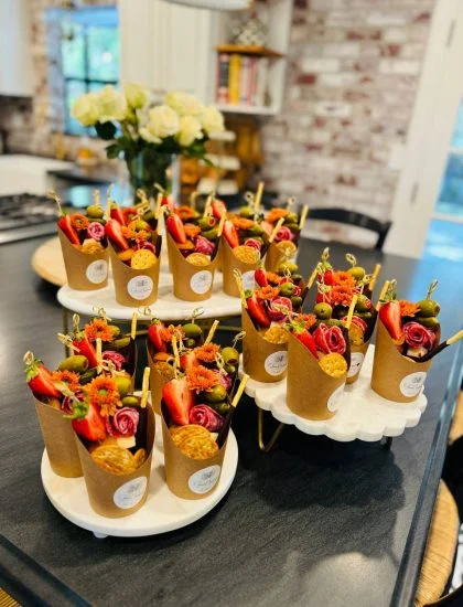 Charcuterie cup with artisan cheese, cured meat, fresh fruit, olives and crackers on display — $13 menu item from Shawna Cheeseboards in Reno NV