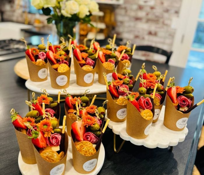 Charcuterie cup with artisan cheese, cured meat, fresh fruit, olives and crackers on display — $13 menu item from Shawna Cheeseboards in Reno NV